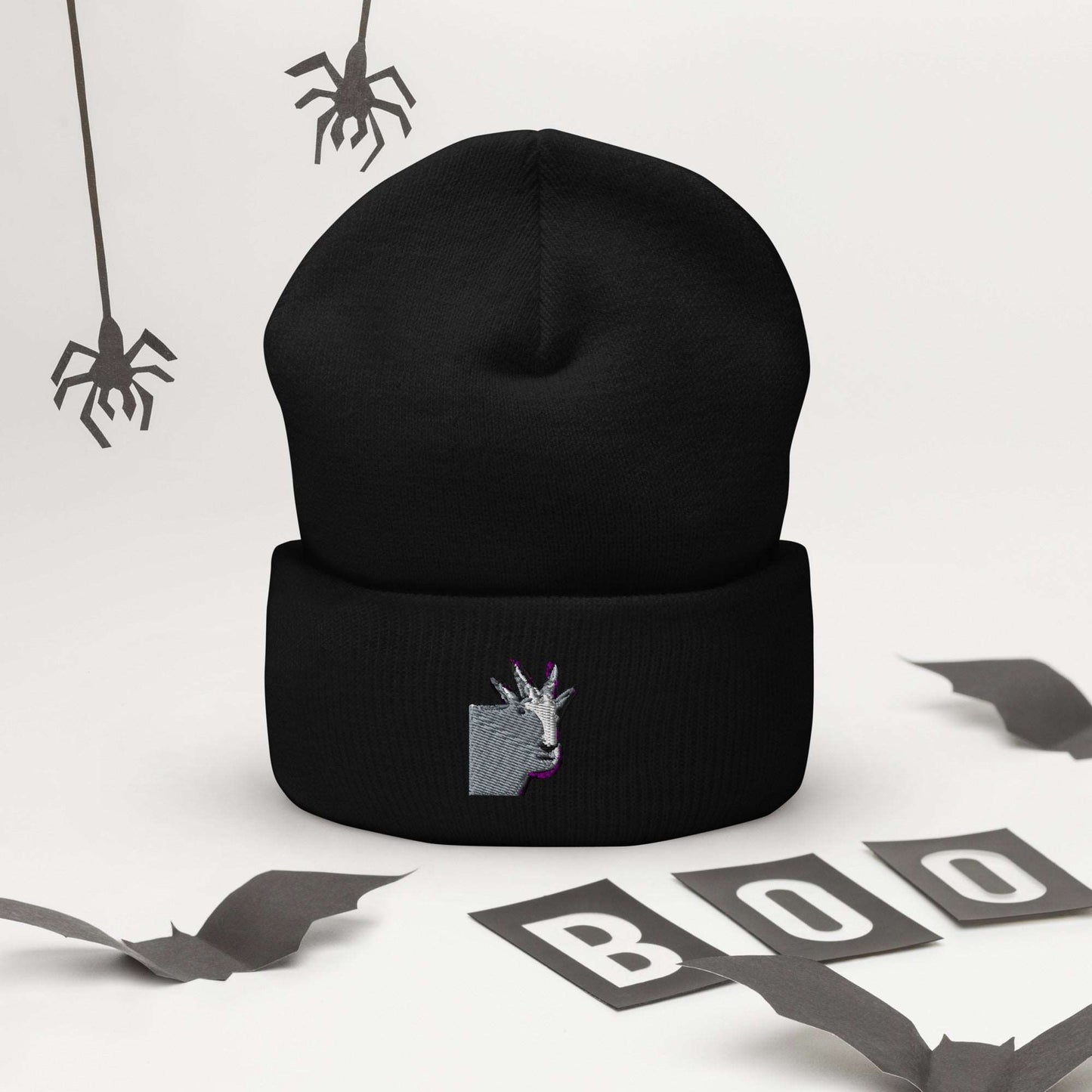 A high-quality black unisex cuffed beanie that has an embroidery of a funny mountain goat design.