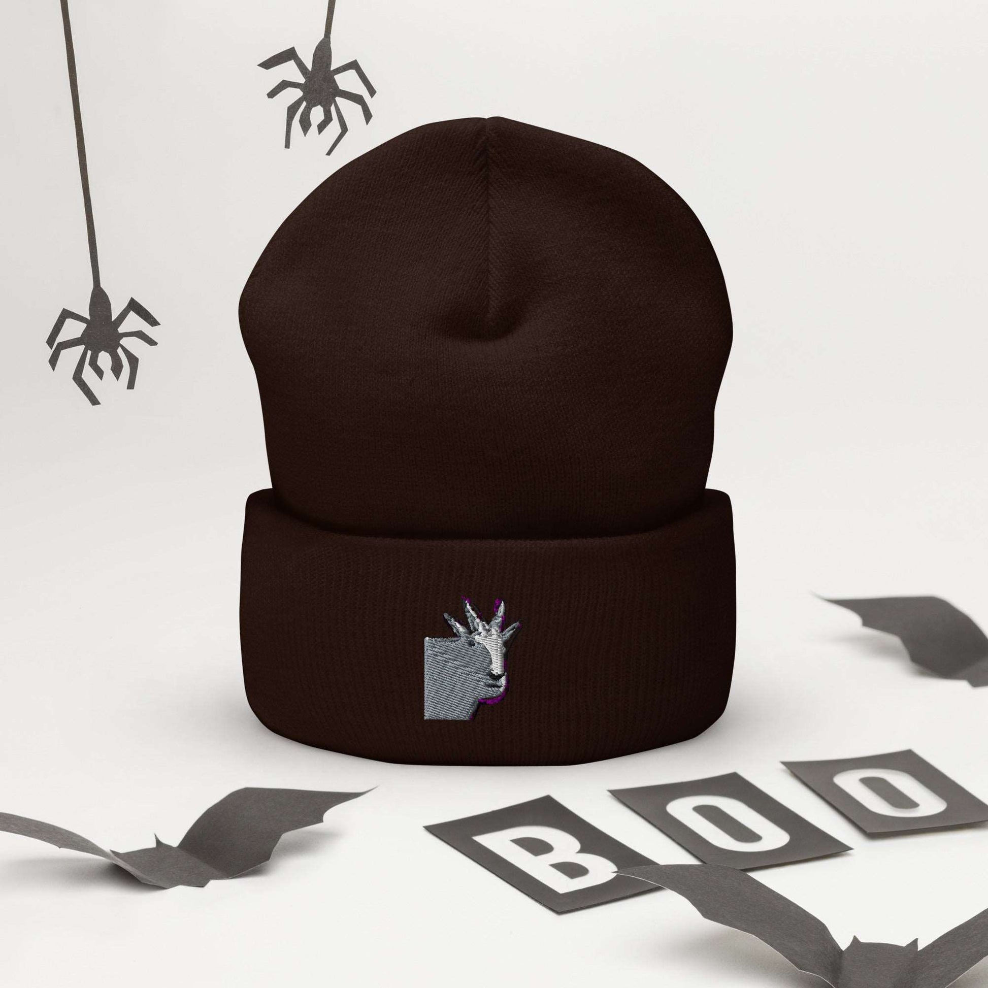 A high-quality brown unisex cuffed beanie that has an embroidery of a funny mountain goat design.