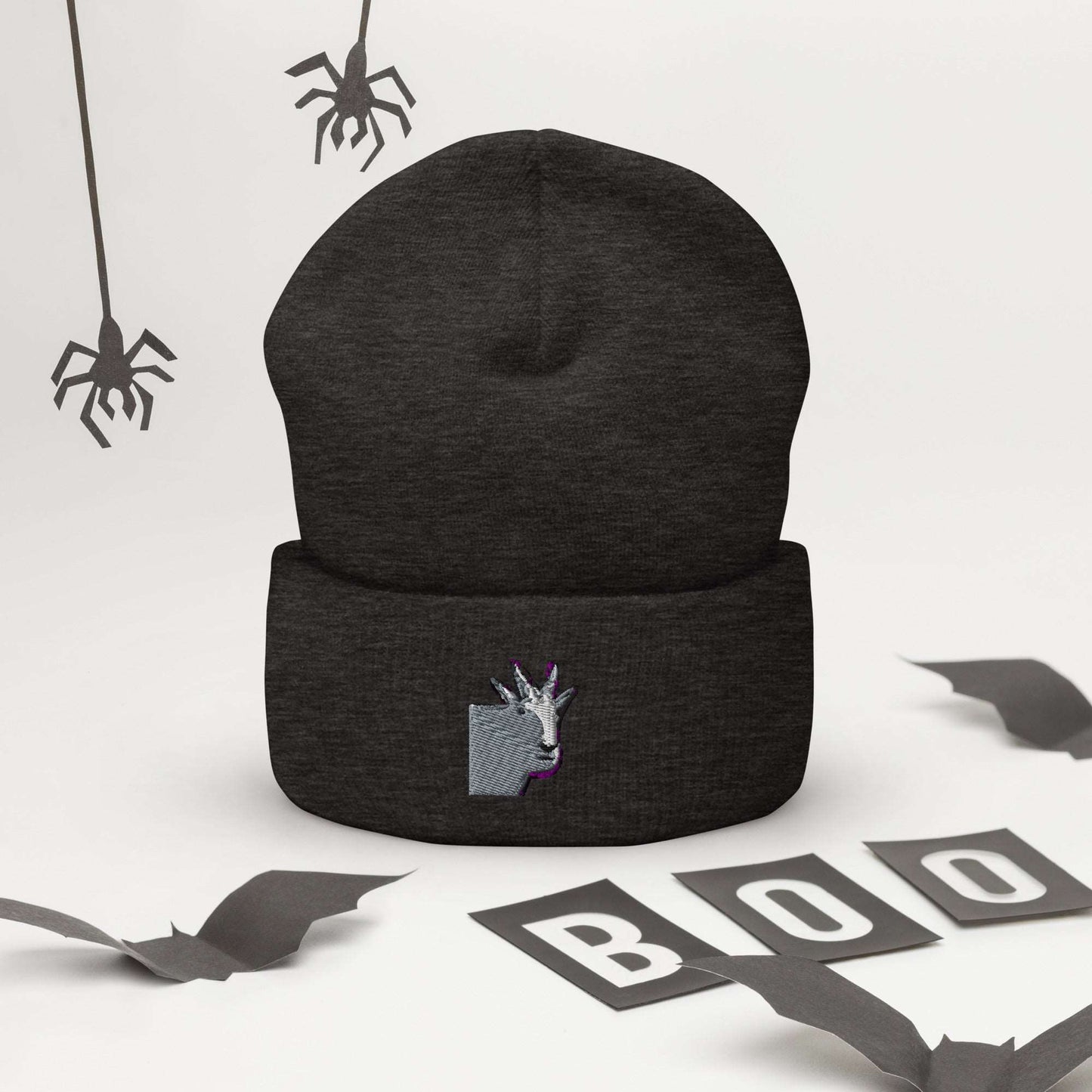 A high-quality dark grey unisex cuffed beanie that has an embroidery of a funny mountain goat design.