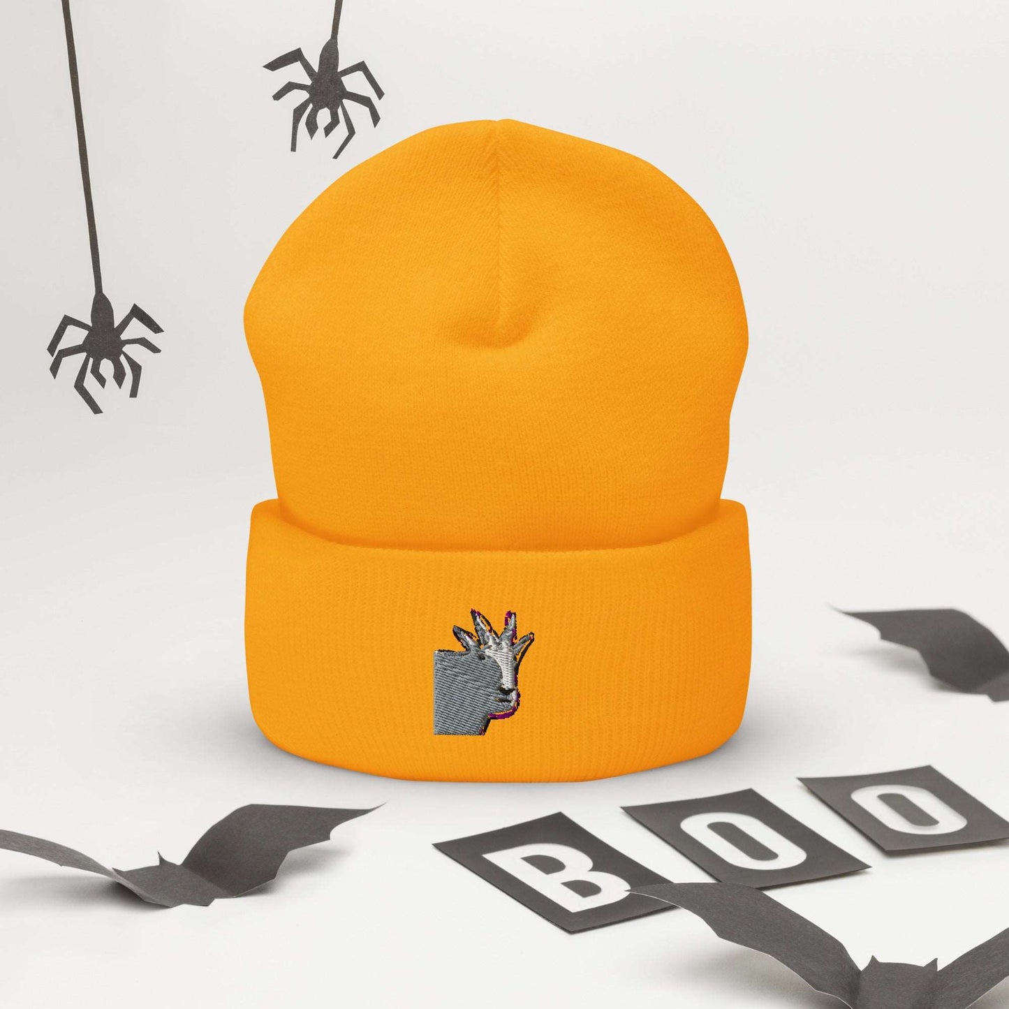 A high-quality yellow unisex cuffed beanie that has an embroidery of a funny mountain goat design.