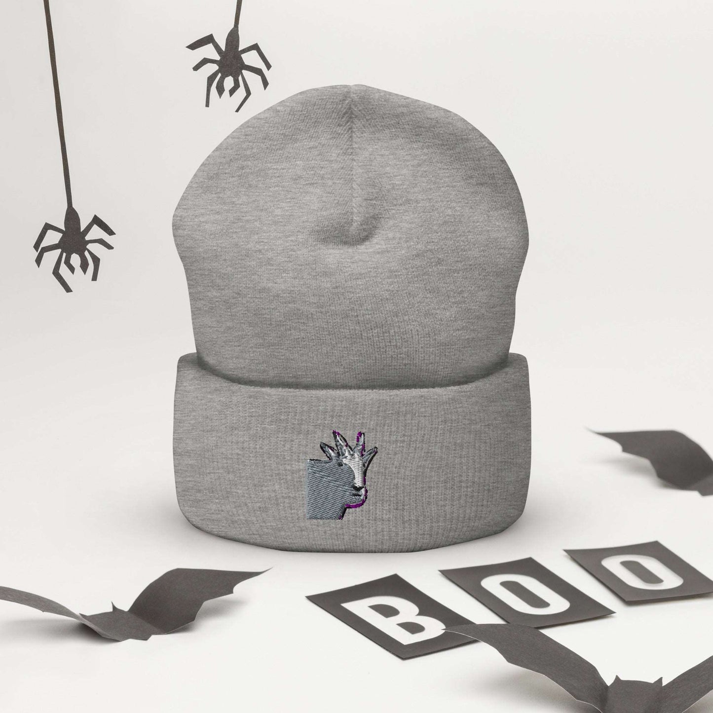 A high-quality light grey unisex cuffed beanie that has an embroidery of a funny mountain goat design.