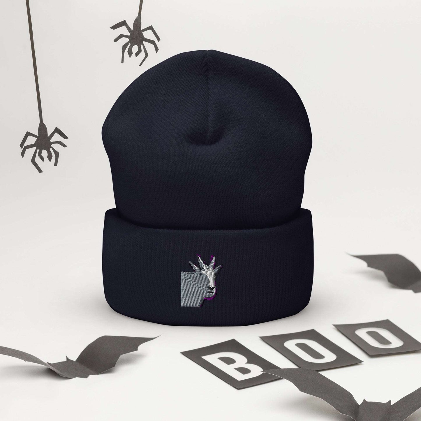 A high-quality navy unisex cuffed beanie that has an embroidery of a funny mountain goat design.