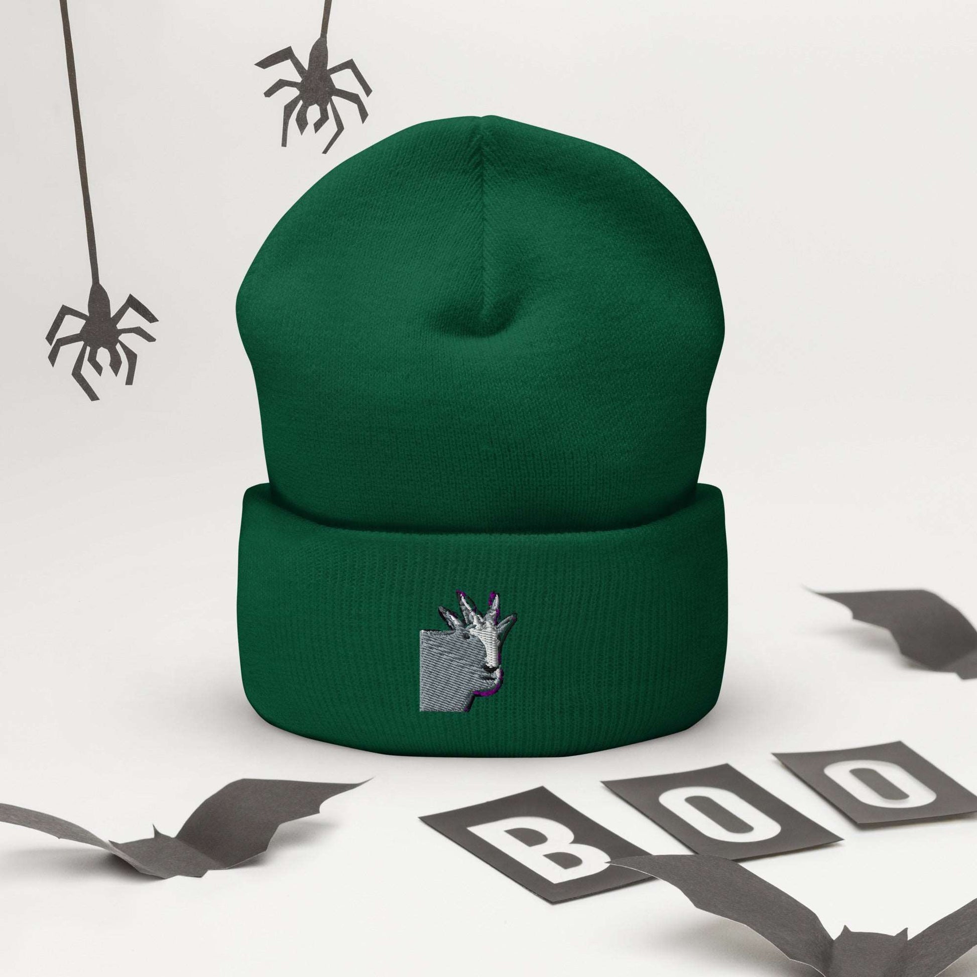 A high-quality spruce green unisex cuffed beanie that has an embroidery of a funny mountain goat design.