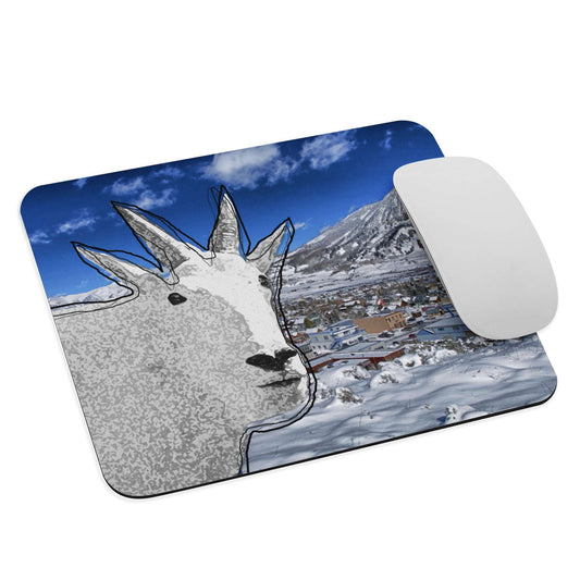 A high-quality mouse pad featuring a funny mountain goat design over a frosty village background.