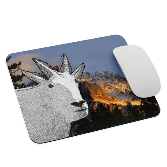 A high-quality mouse pad featuring a funny mountain goat design over a mountain dusk background.