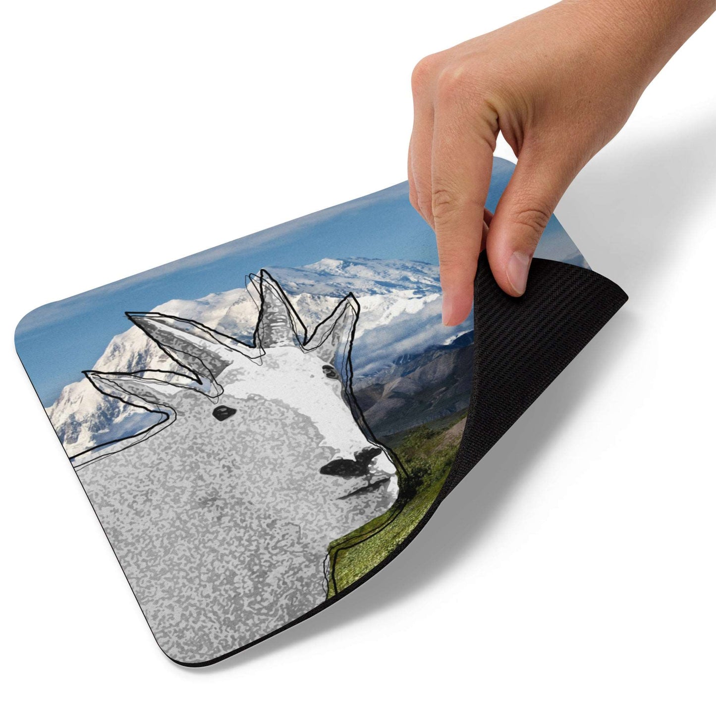 A high-quality mouse pad featuring a funny mountain goat design over a mountain view background.