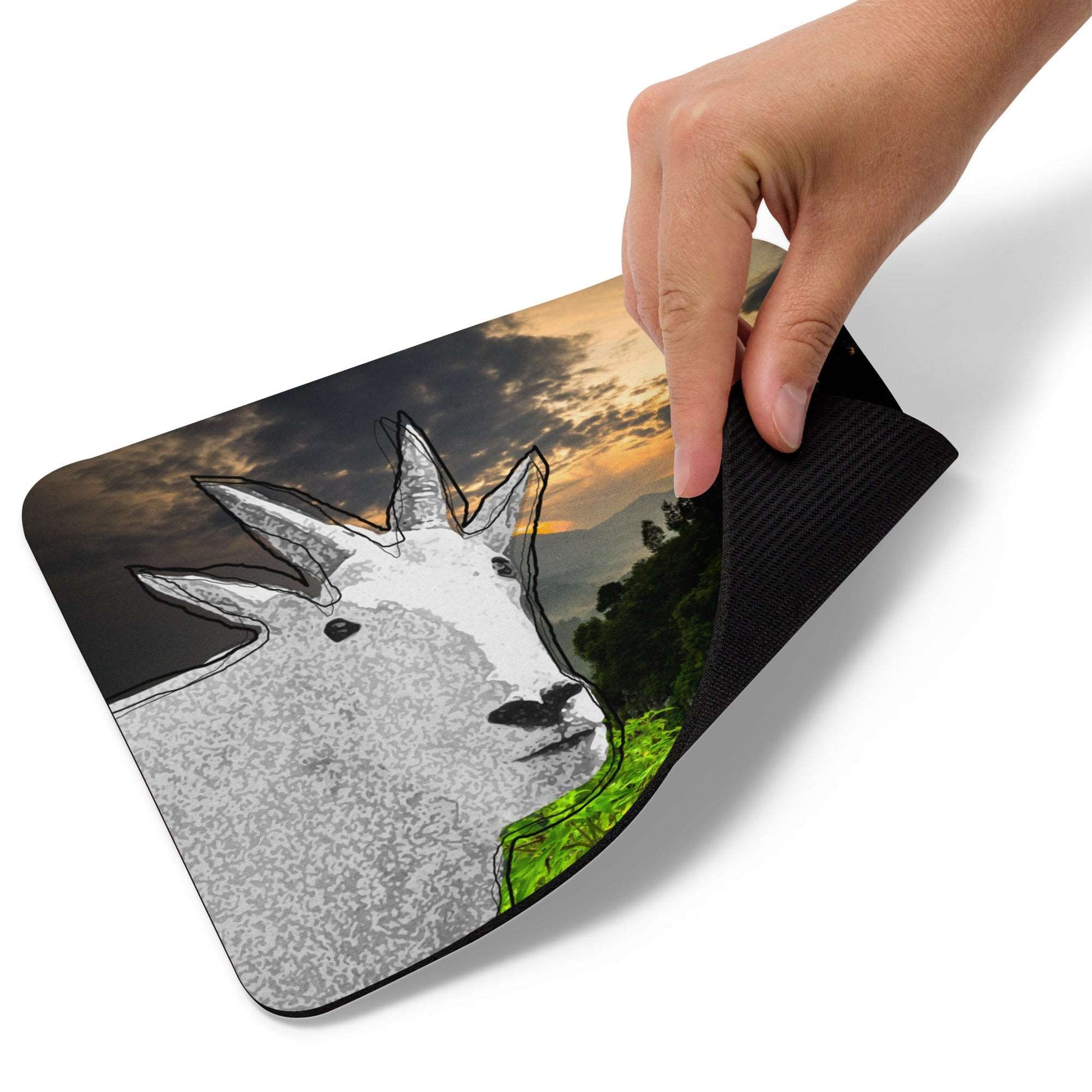 A high-quality mouse pad featuring a funny mountain goat design over a vibrant nature background.