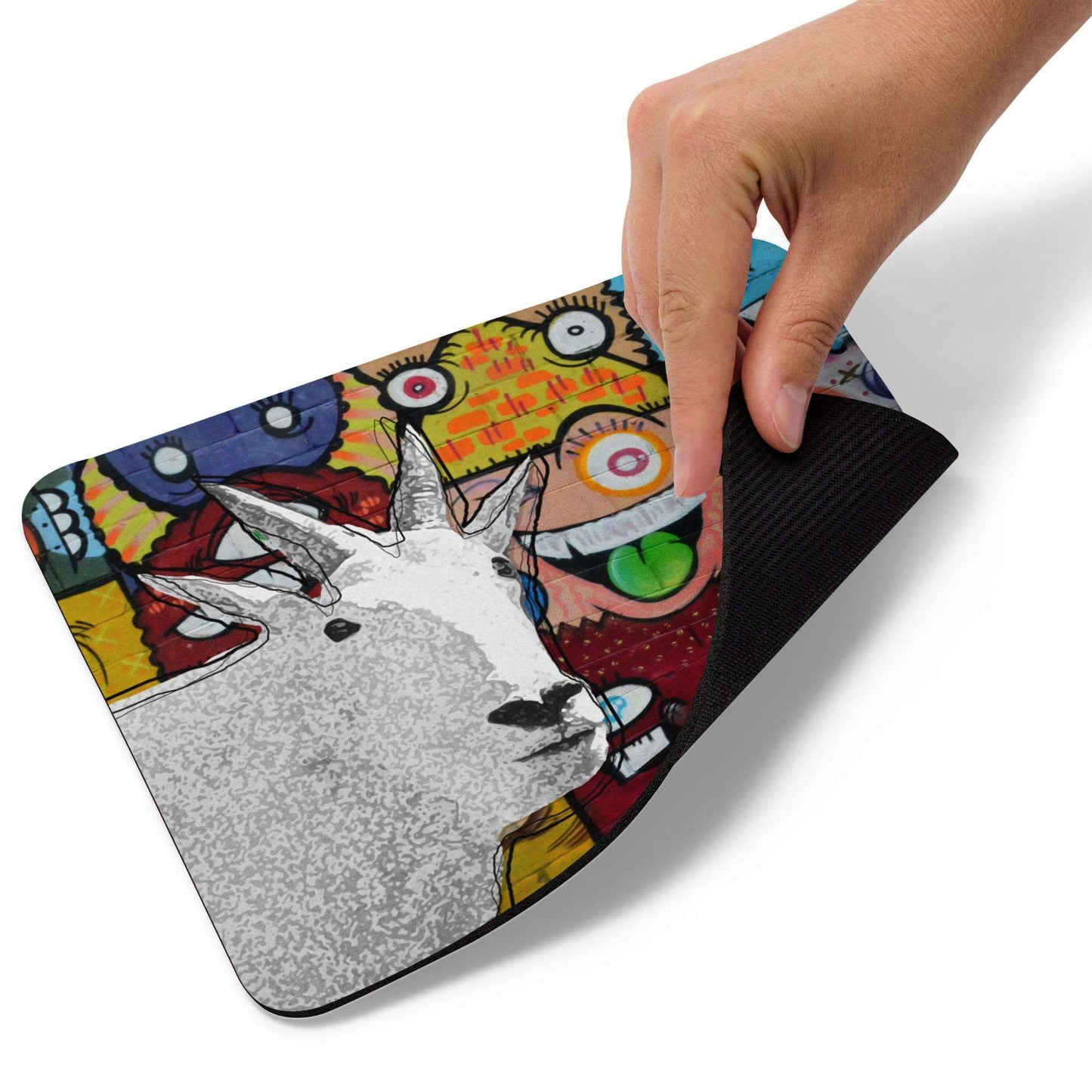 A high-quality mouse pad featuring a funny mountain goat design over a funky street art background.