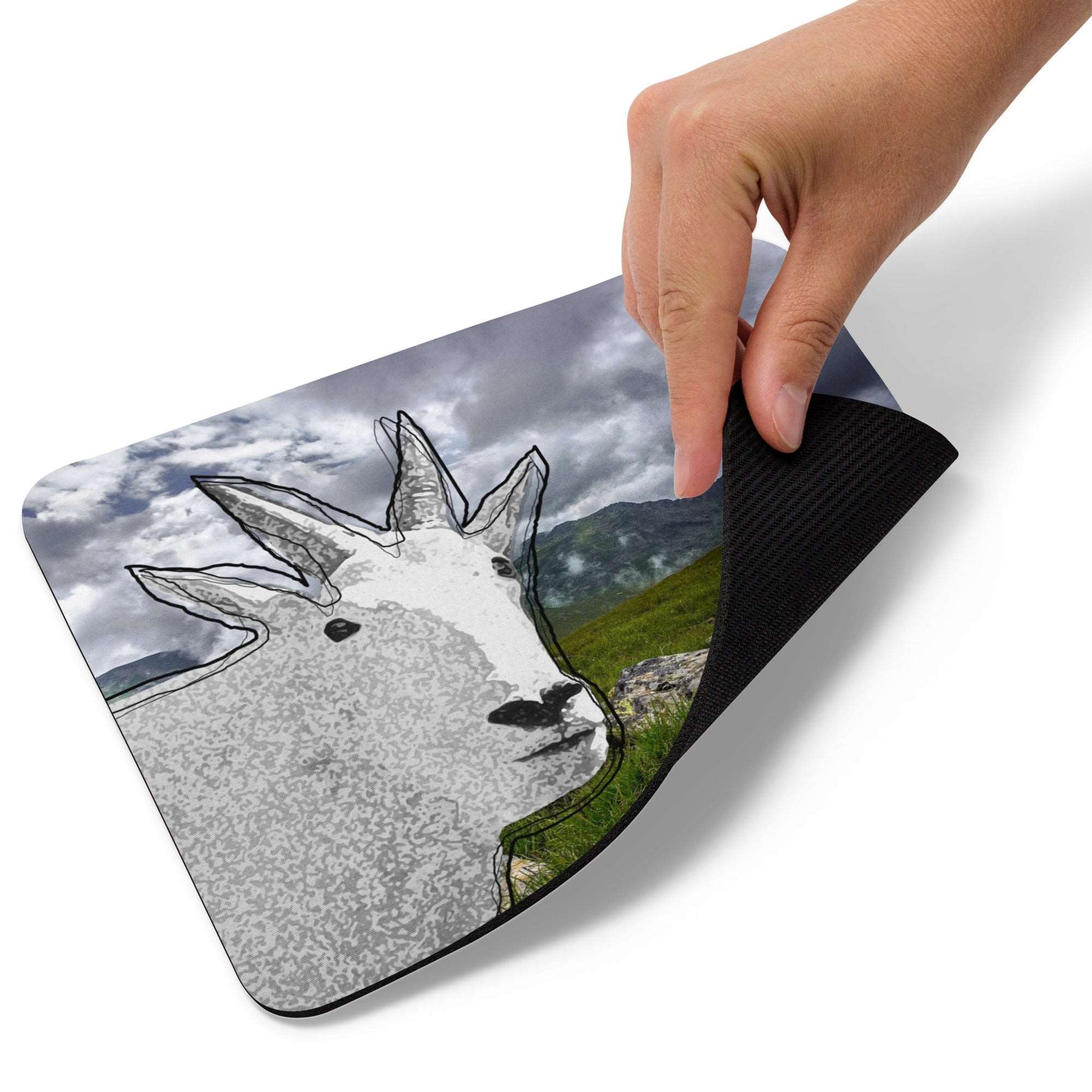 A high-quality mouse pad featuring a funny mountain goat design over Mt Rainer background.