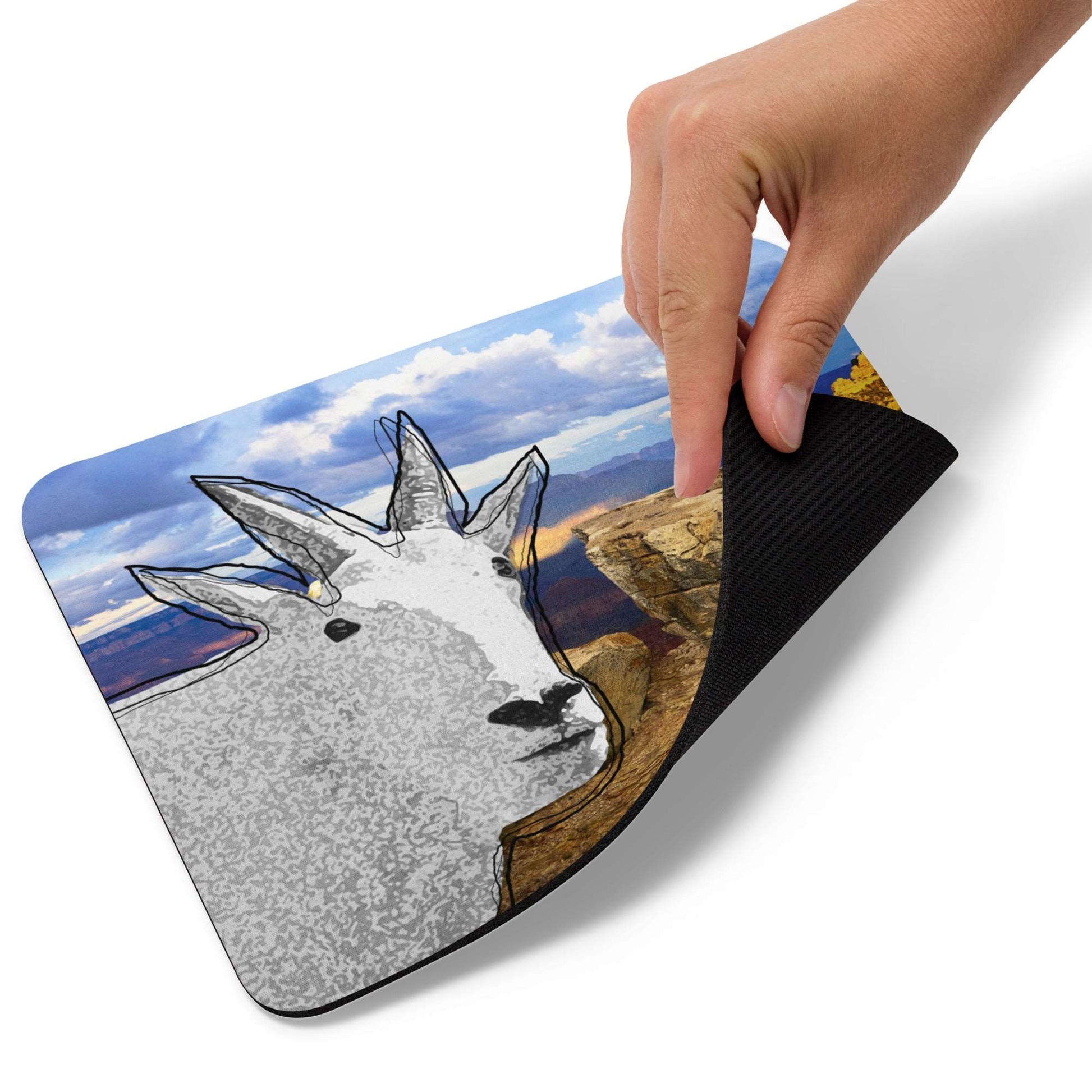 A high-quality mouse pad featuring a funny mountain goat design over panorama background.