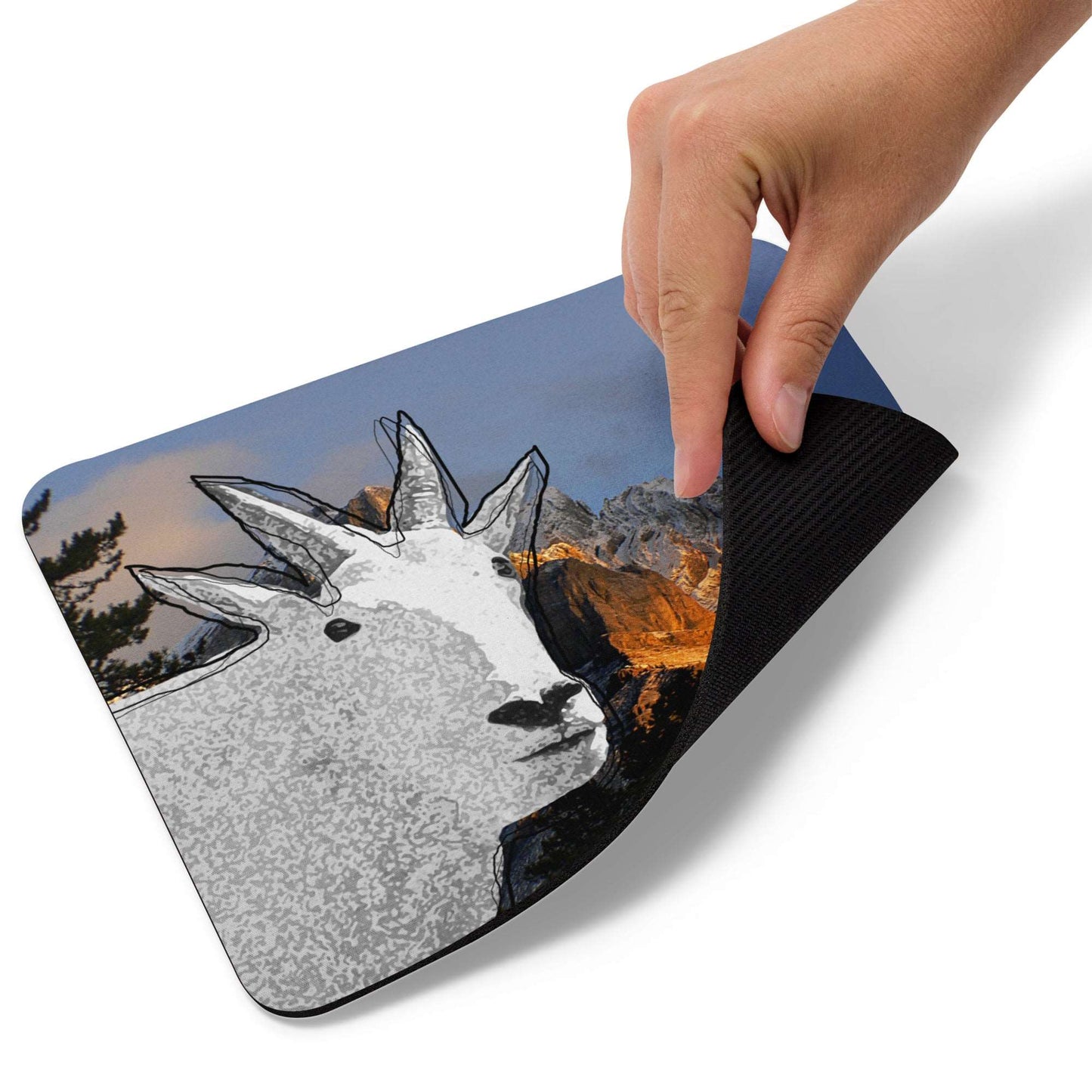 A high-quality mouse pad featuring a funny mountain goat design over a mountain dusk background.