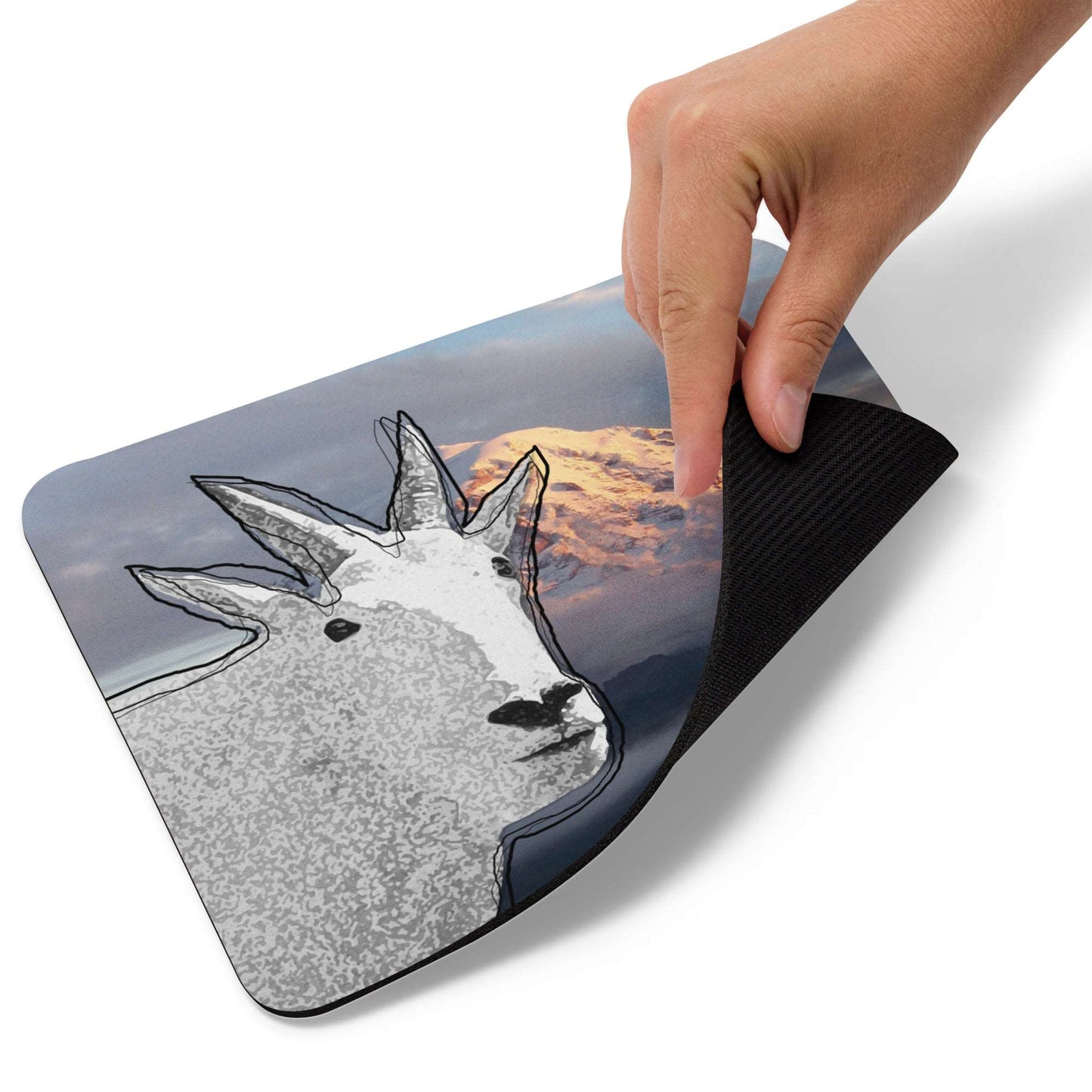 A high-quality mouse pad featuring a funny mountain goat design over a misty mountain background.