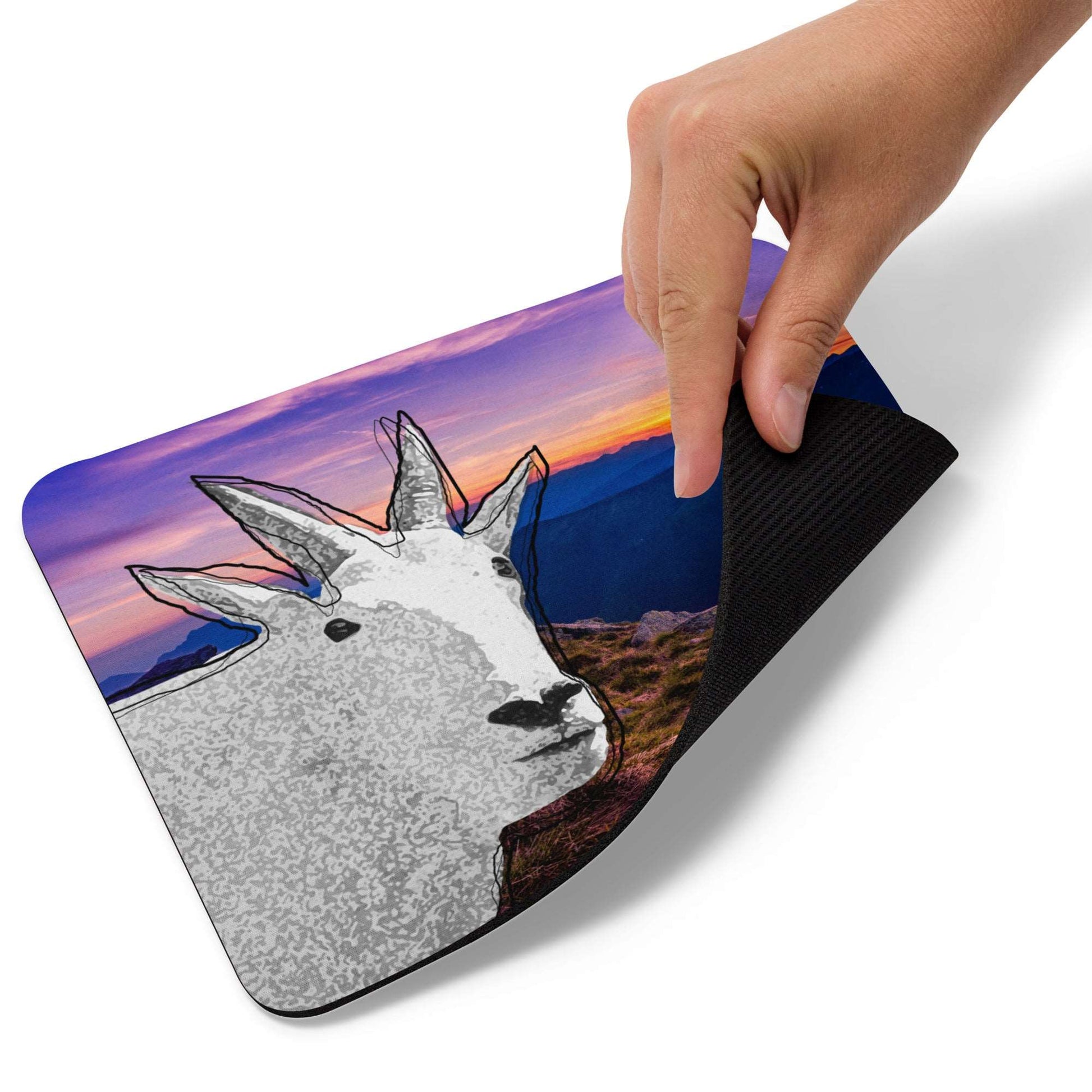 A high-quality mouse pad featuring a funny mountain goat design over a gorgeous sunset background.