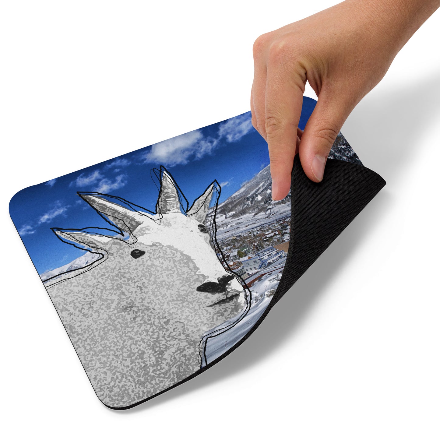 A high-quality mouse pad featuring a funny mountain goat design over a frosty village background.