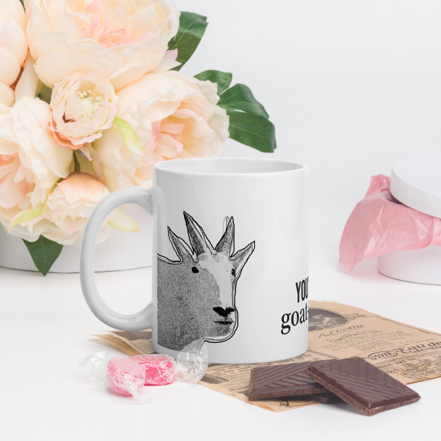 A white glossy mug that has a funny mountain goat design, the quote "You're My Goat-To Guy", and the logo North American Mountain Goat Appreciation Club.