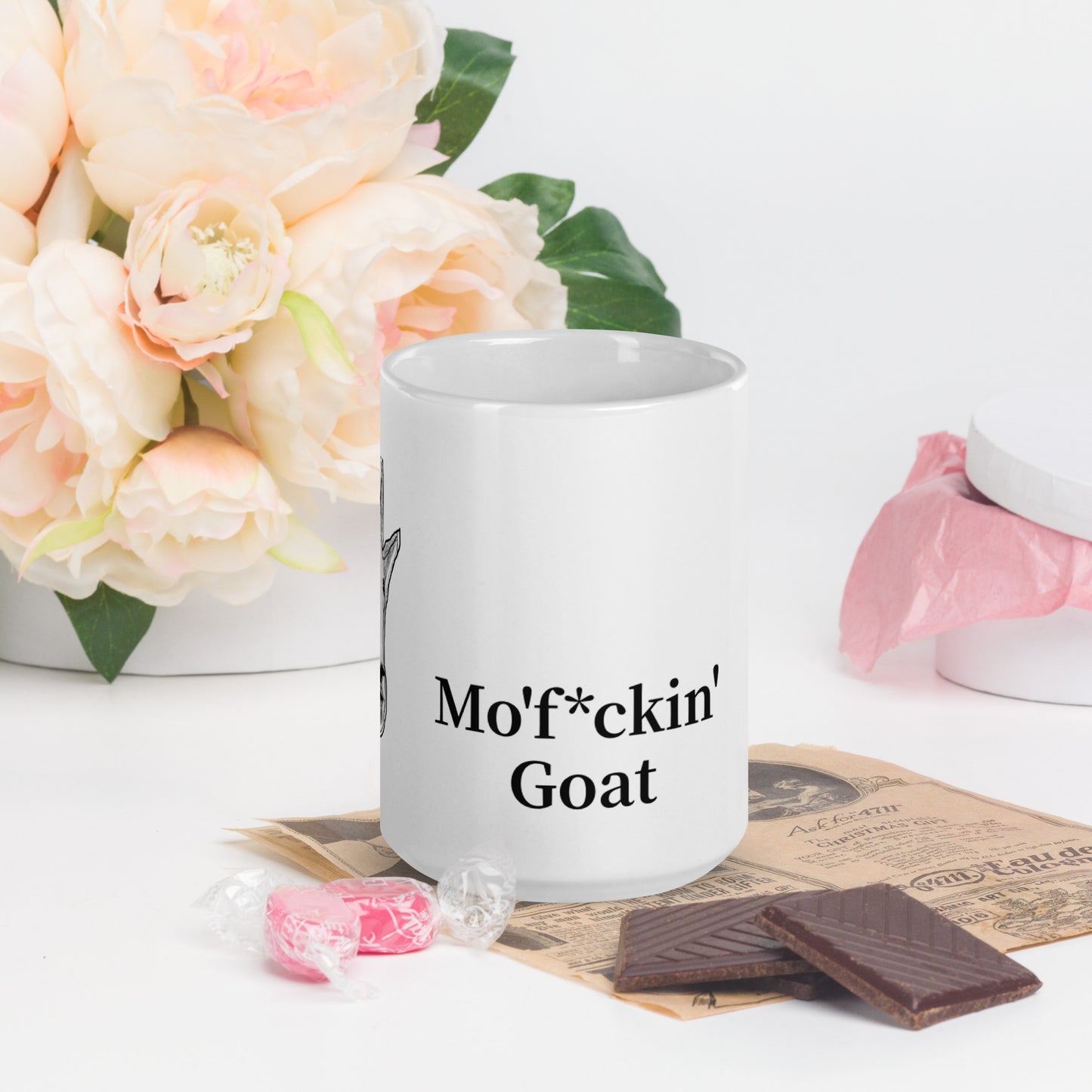 A white glossy mug that has a funny mountain goat design, the quote "Mo'f*ckin' Goat", and the logo North American Mountain Goat Appreciation Club.