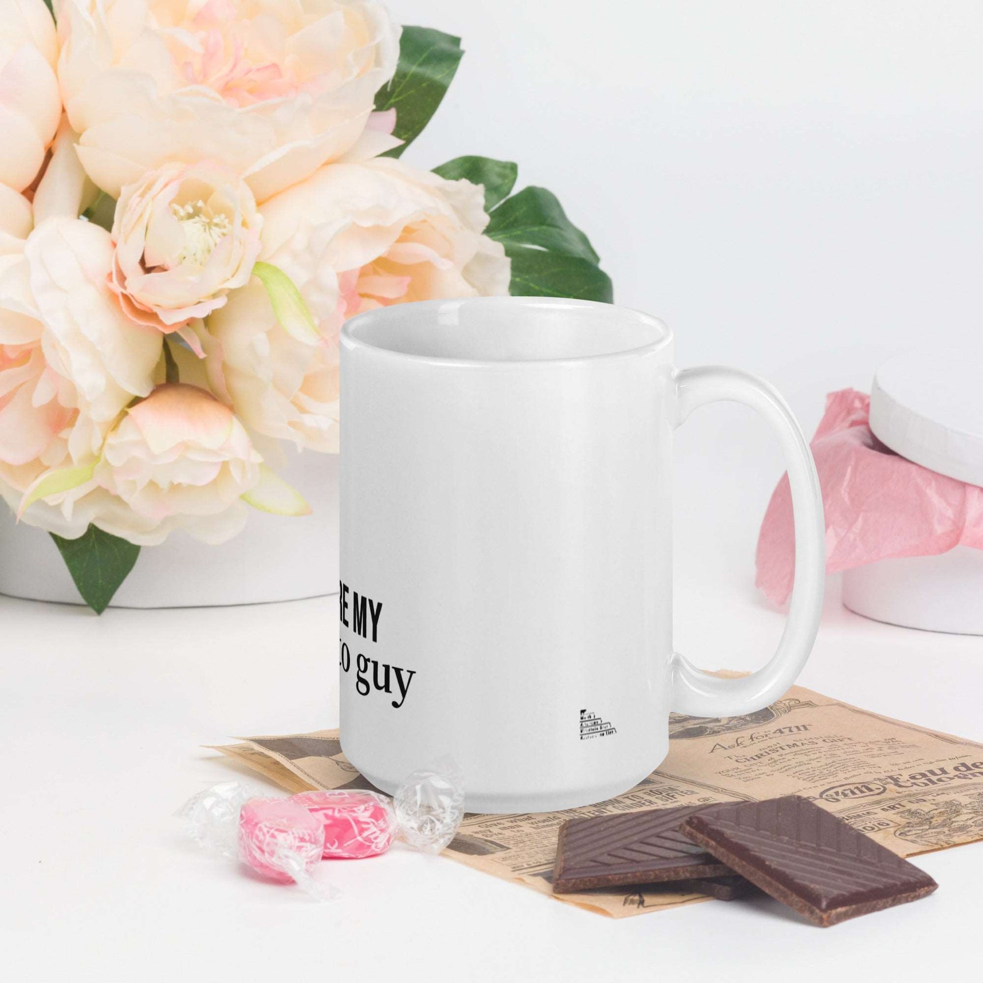 A white glossy mug that has a funny mountain goat design, the quote "You're My Goat-To Guy", and the logo North American Mountain Goat Appreciation Club.