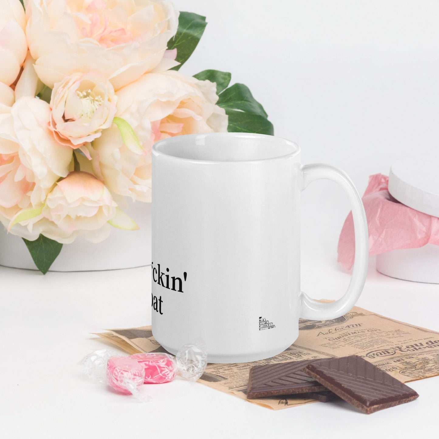 A white glossy mug that has a funny mountain goat design, the quote "Mo'f*ckin' Goat", and the logo North American Mountain Goat Appreciation Club.